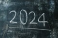 2024 date handwritten in a chalk writing text script on a wooden black chalkboard