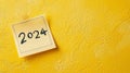 2024 date handwritten in a text script with a black marker pen on paper note pad memo placed on a yellow background Royalty Free Stock Photo