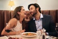 Date, laughing and playful couple eating spaghetti on a romantic dinner at a restaurant and enjoying a meal. Lovers, man Royalty Free Stock Photo