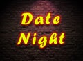 Date Night Neon sign On brick wall background. Royalty Free Stock Photo