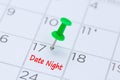 Date Night written on a calendar with a green push pin to remin Royalty Free Stock Photo