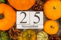 Date 25 november, thanksgiving, surrounded pumpkins