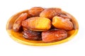 Date palm fruits in wooden bowl on white background