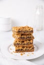 Date squares or Matrimonial cake stacked on a plate in a white kitchen