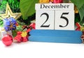 Date 25th December with plants and Christmas decoration background