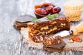 Date walnut wedge with multigrain crackers on wooden table