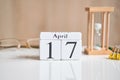 Date on white wooden cubes - the seventeenth, 17 April on a white table