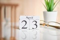 Date on white wooden cubes - the twenty third, 23 April on a white table Royalty Free Stock Photo