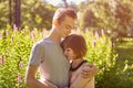 Date of a young couple in love in a public park, a guy hugs a sad girl Royalty Free Stock Photo