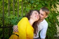 A date between a young girl and a guy on a Sunny summer day. Young beautiful couple on walk in the city. Man and woman at a love Royalty Free Stock Photo