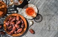 Dates on copper plate, next to red tea in glass of armudu and teapot. Layout of sweet date fruits on stone background, bright Royalty Free Stock Photo