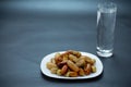 Nigeria local dates with glass of water on black background