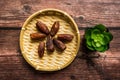 Dates or kurma on a wooden table with flower pot Royalty Free Stock Photo