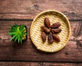 Dates or kurma on a wooden table with flower pot Royalty Free Stock Photo