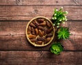 Dates or kurma on a wooden table with flower pot Royalty Free Stock Photo