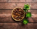 Dates or kurma on a wooden table with flower pot