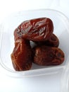 Dates in a plastic bowl