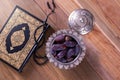 Dates with rosary and holy quran on wooden background top view.-Ramadan kareem/Eid al fitr Concept