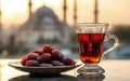 Dates and Tea at Sunset with Mosque Background Royalty Free Stock Photo