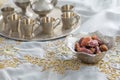 Dates and zam zam water cups on white table cloth