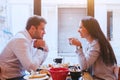 Dating, man and woman laughing together in restaurant, happy couple drinking coffee for breakfast Royalty Free Stock Photo