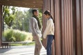 Young asian couple talking chatting outdoors in city park Royalty Free Stock Photo