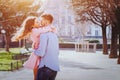 Dating, young happy caucasian couple kissing and laughing outside