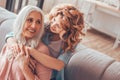 Daugher hugging mother sitting on the sofa at home Royalty Free Stock Photo