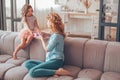 Daugher and mother sitting on the couch and celebration mothers day with the present Royalty Free Stock Photo