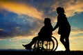 Daughter accompanies her mother in wheelchair