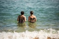 And daughter in bikini entering the water at Porto da Barra beach in Salvador, Bahia Royalty Free Stock Photo