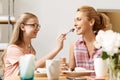 Daughter bonding to her mother while feeding her Royalty Free Stock Photo