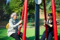A daughter brought her elderly mother to an outdoor fitness field in the neighborhood. Royalty Free Stock Photo