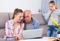 Daughter calling busy parents to play tennis Royalty Free Stock Photo