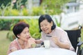 Daughter caring for the elderly asian woman ,picking a chocolate