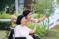 Daughter caring for the elderly asian woman ,do selfie