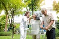 Daughter caring for elderly parents Take a walk in the garden for physical therapy to stay healthy. Royalty Free Stock Photo