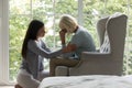 Daughter comforting elderly mother sharing difficult life period giving support