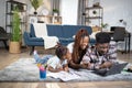 Daughter drawing while parents using modern laptop Royalty Free Stock Photo