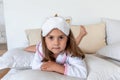 Daughter are dressed in white terry robes, lie on the bed. Nursing communication in the family