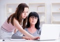 Daughter explaining to mom how to use computer Royalty Free Stock Photo