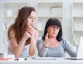 Daughter explaining to mom how to use computer Royalty Free Stock Photo