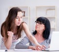 Daughter explaining to mom how to use computer Royalty Free Stock Photo