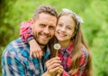 Daughter and father with dandelion flower. family summer farm. little girl and happy man dad. earth day. spring village Royalty Free Stock Photo