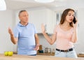 Daughter father scolding and yelling at her in home kitchen