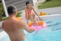 Cute blonde daughter feeling scared while swimming in pool Royalty Free Stock Photo