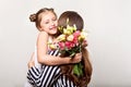 Daughter gives flowers to her mother on her mother`s day