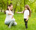 The daughter gives to mother a dandelion