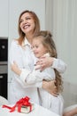 Daughter giving her mother a christmas present Royalty Free Stock Photo