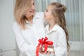 Daughter giving her mother a christmas present Royalty Free Stock Photo